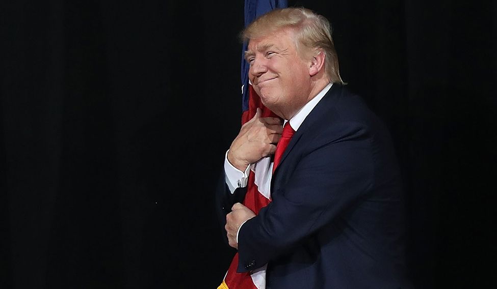 Catching up: Trump hugs the flag as he arrives at a rally in Naples, Florida | AFP Slippery swings