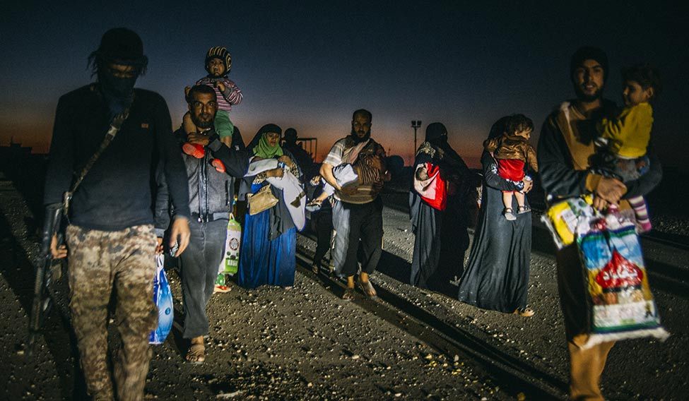 All is not lost: Families fleeing Mosul at night. All is not lost: Families fleeing Mosul at night.