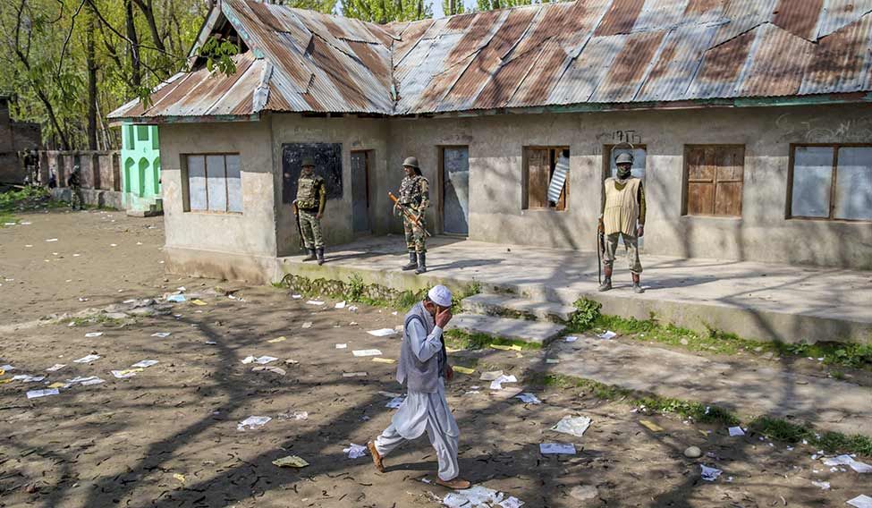 Guarding rights: A man returns from a polling station in Dooniwari | AP When imagination fails...