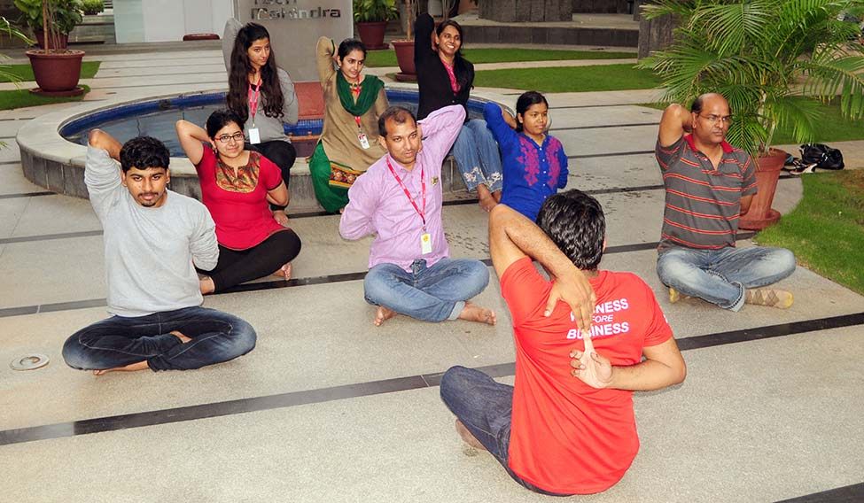 BACK TO BACK- Employees at a yoga session in Tech Mahindra, Hyderabad | K.R. Vinayan Fit, for the job