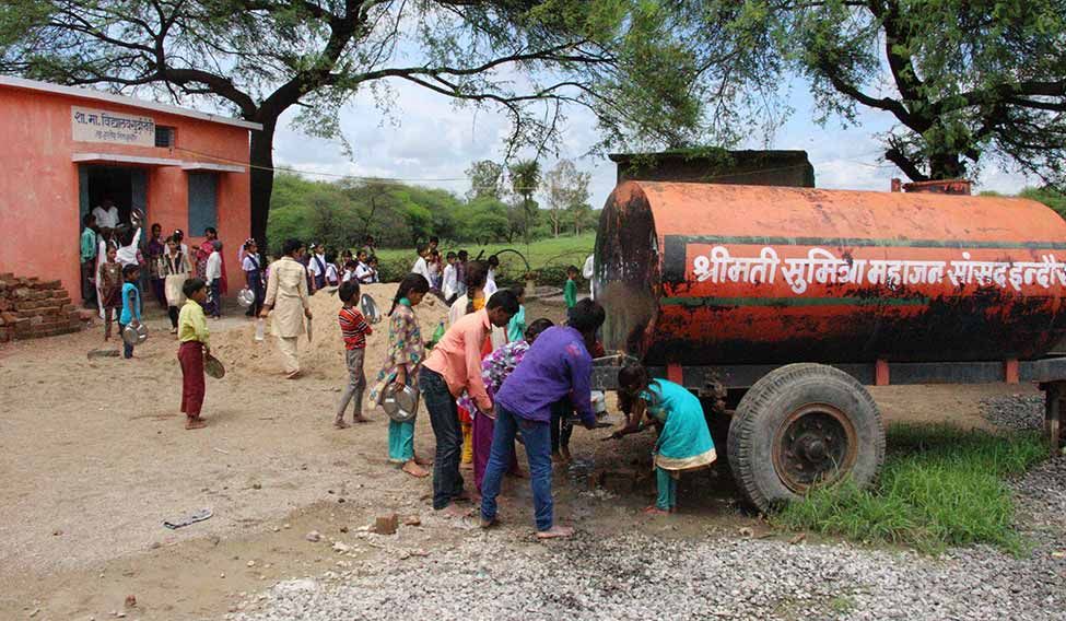Students at the zero-teacher middle school in Gurdakhedi village near Indore taking water from a tanker. Indore has the highest number of surplus teachers in urban areas—1,047 | Photographs: Vivek Pateria Lessons in negligence
