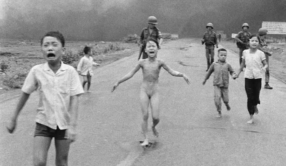 FILE - In this June 8, 1972, file photo taken by Huynh Cong “Nick” Ut, South Vietnamese forces follow behind terrified children, including 9-year-old Kim Phuc, center, as they run down Route 1 near Trang Bang after an aerial napalm attack on suspected Viet Cong hiding places | AP Children of war
