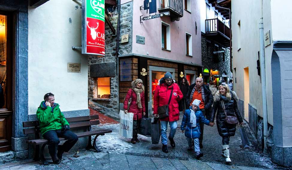 Winter revellers in Courmayeur village Quaint-essential charms