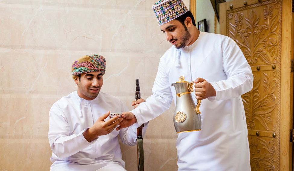 Two men having traditional Omani coffee Laden with history