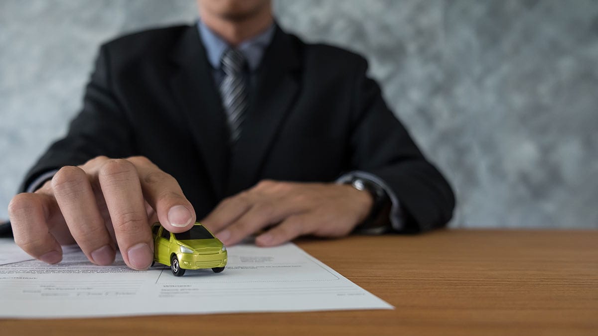 transportation and ownership concept - customer and salesman with car key
