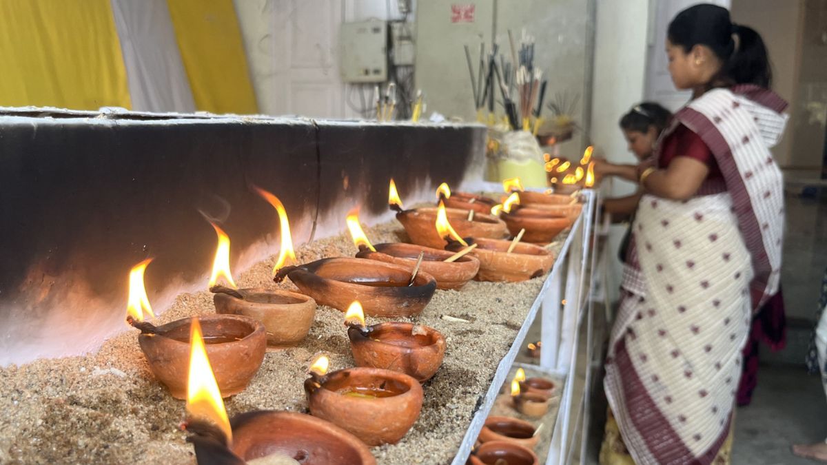 Women light diyas as part of the Uzanbazar Barowari Durga Puja in Guwahati | Salil Bera