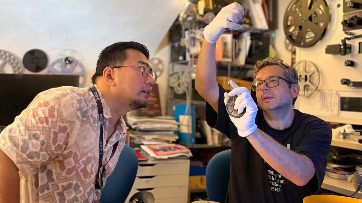 Johnson Rajkumar discusses the conditions of the 8mm films with a lab technician at National Archive of Family Films in Bologna, Italy | Deepika Gurumayum
