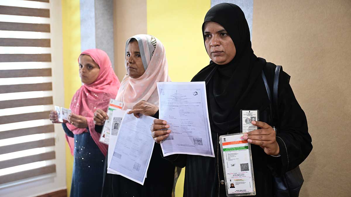 Identity crisis: Mahabubi Sheik, Razia Sheik and Malanbi Jamadar, whose names were included in a list of dead voters, produce their Aadhaar and other documents before the media in Bengaluru | Bhanu Prakash Chandra