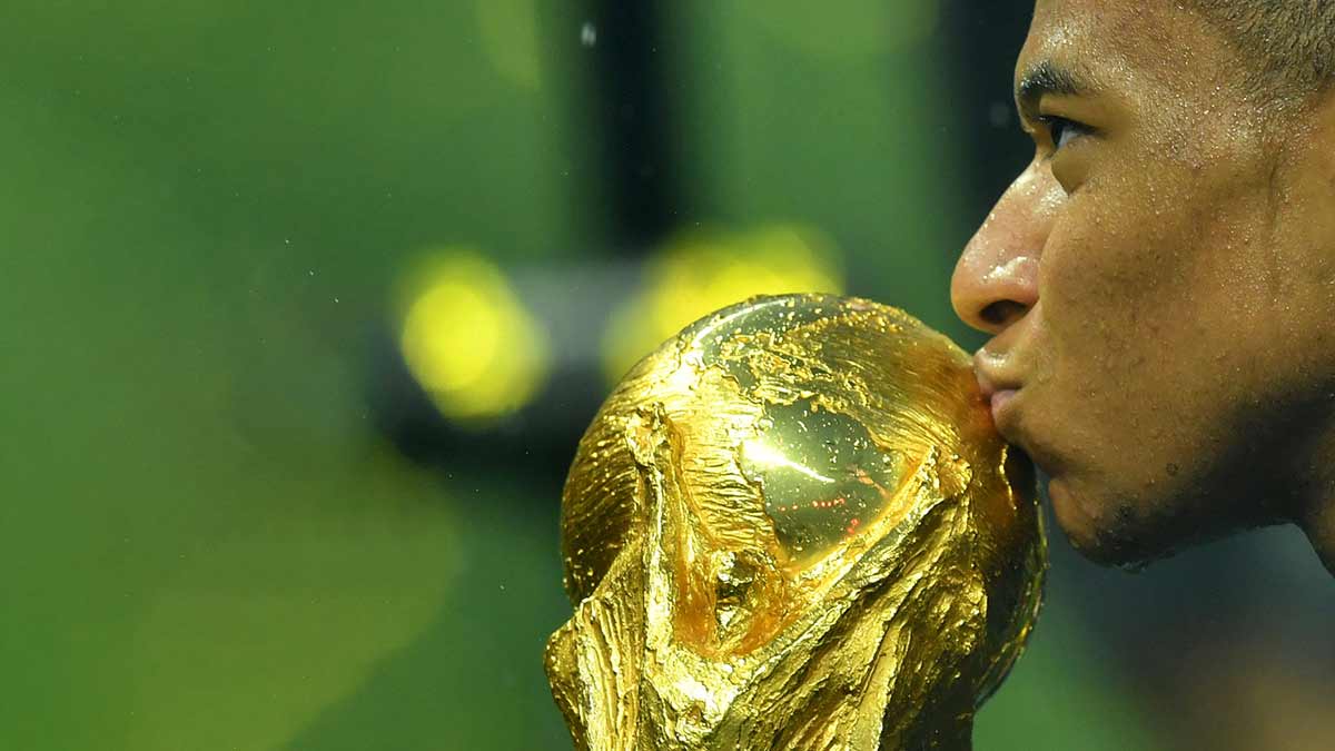 Golden boy: Mbappe kisses the World Cup trophy in 2018 | Reuters