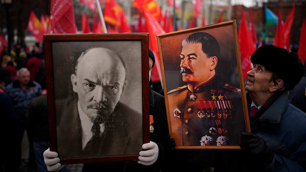 Revolutionary zeal: Communist supporters hold portraits of Lenin and Stalin as they observe the 'Defender of the Fatherland Day' in Moscow,  on February 23, 2022 | AP