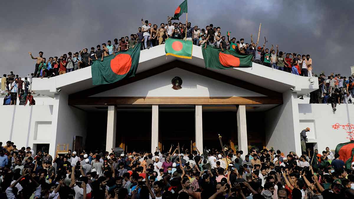Raging high: Protesters display Bangladesh’s national flag as they storm prime minister Sheikh Hasina’s palace in Dhaka on August 5, 2024 | AFP