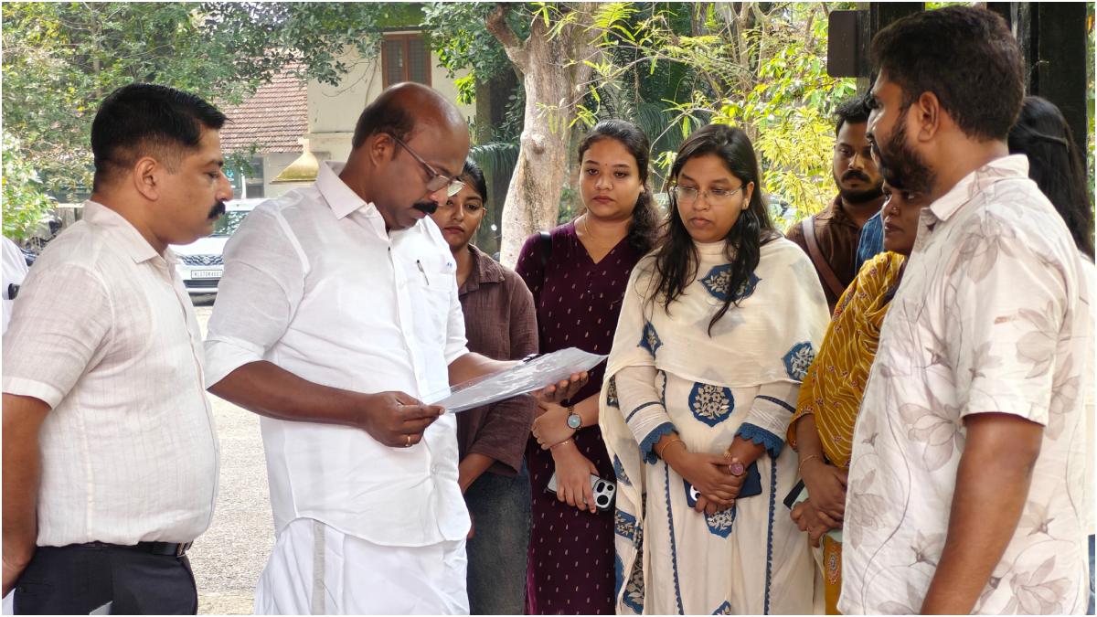 Vishnu T.P., chief promoter, and Jijy Philip, founder and CEO of UACC and consultant to the project, submit the project report for a proposed cooperative-sector IT venture by former Coro Health employees to Cooperation Minister M. Liju in Thiruvananthapuram