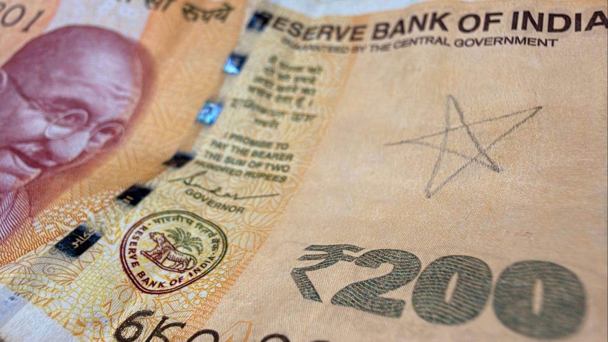 A 200 rupee note received from a shopkeeper bearing a pencil mark