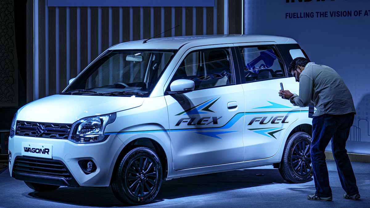 An official takes photographs of a newly-launched Maruti Suzuki Wagon R during the launch of India's first flex fuel car, in New Delhi | PTI