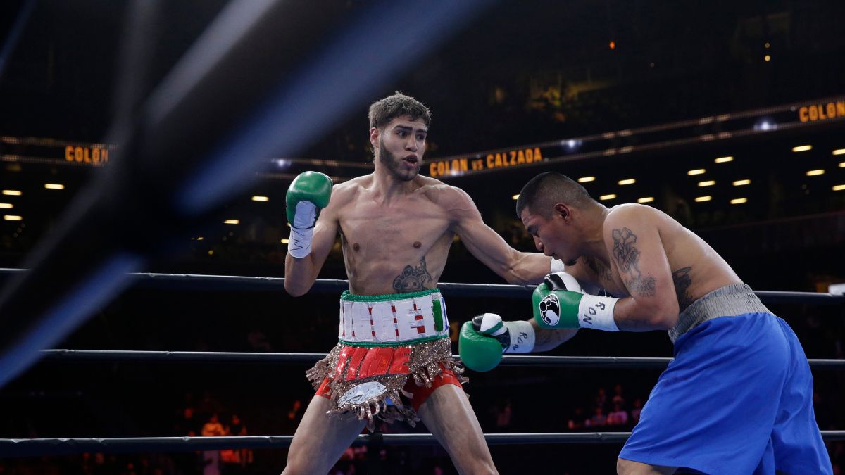 Prichard Colon, left, exchanges punches with Daniel Calzada during a junior middleweight title boxing match, Saturday, April 11, 2015, at New York. Colon won by TKO. (AP Photo/Mary Altaffer, file)