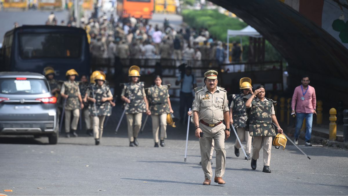 Delhi police officers stand guard at barricades blocking roads leading to the site of a protest by the Cockroach Janta Party demanding the resignation of Chief Election Commissioner Gyanesh Kumar in New Delhi | Kritajna Naik