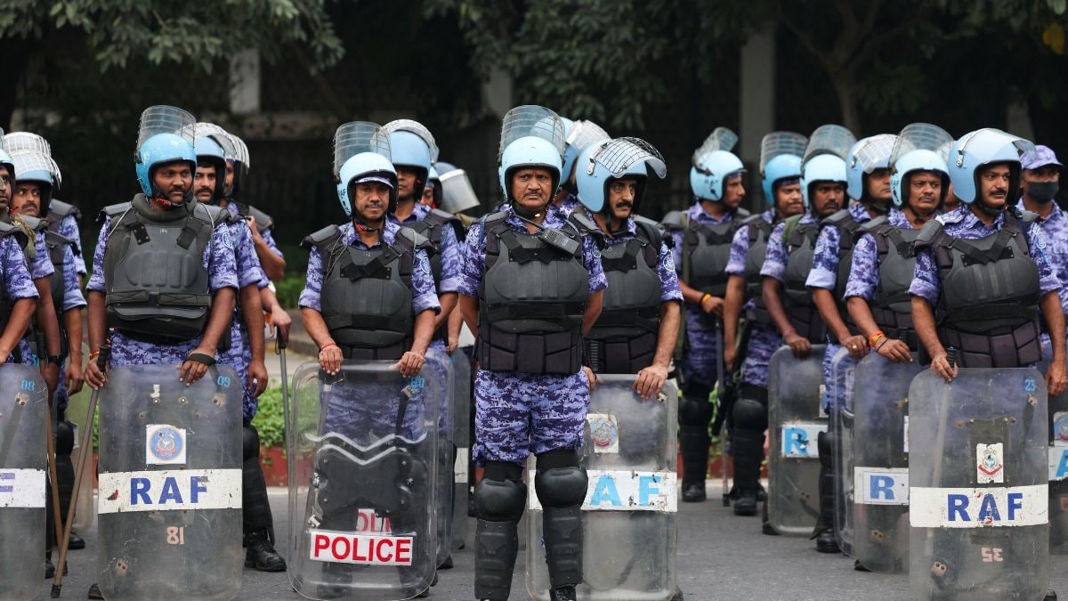 Members of the Rapid Action Force (RAF) stand guard ahead of a protest planned by the Cockroach Janta Party (CJP) seeking the resignation of CEC Gyanesh Kumar, near the protest site in New Delhi | Reuters