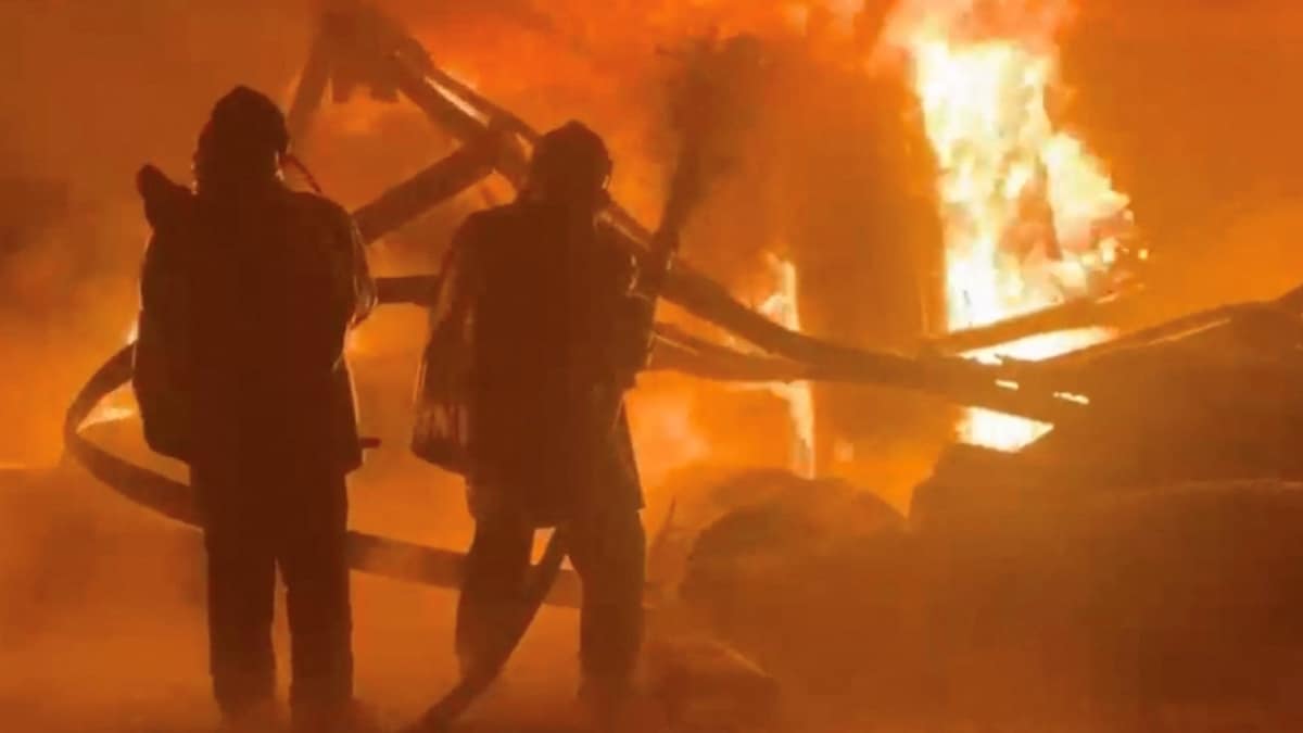 Emergency services personnel douse a fire after a reported Russian attack on an industrial facility in a location given as Bucha district of Kyiv region | Reuters