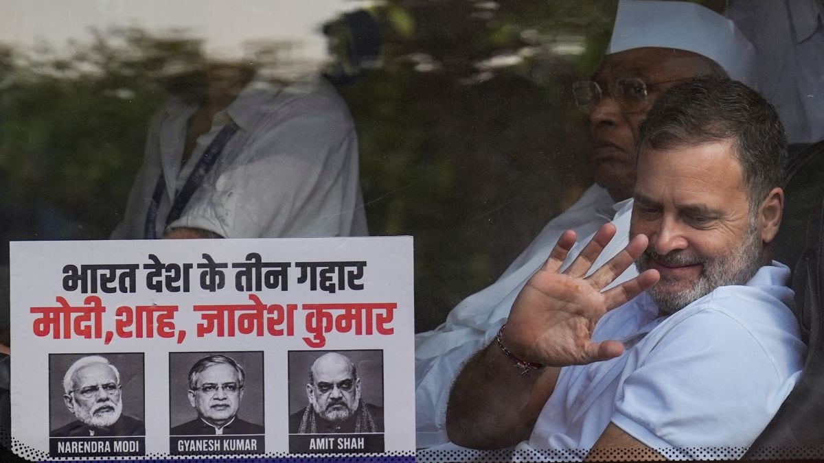 Congress President Mallikarjun Kharge looks on as party leader Rahul Gandhi greets the supporters from a bus, proceeding towards Rajghat for a peaceful protest | PTI