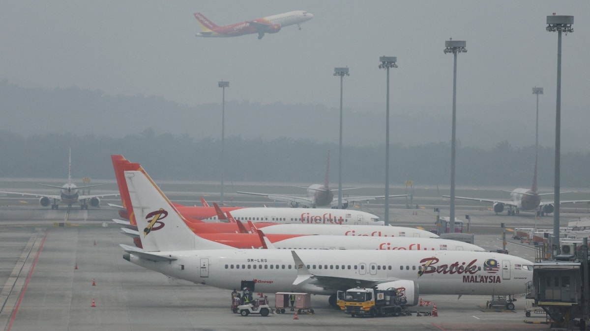 Aircraft are parked on the haze-shrouded tarmac at Kuala Lumpur International Airport in Sepang, Malaysia | Reuters