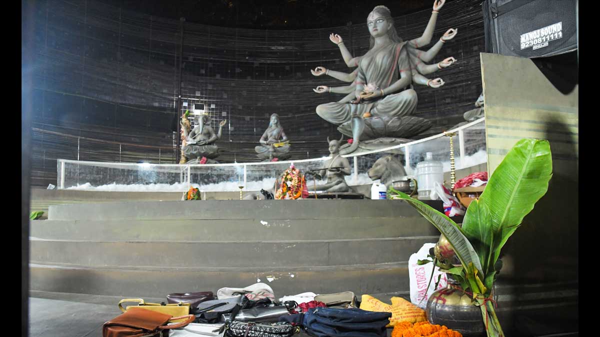 Purses and other belongings left behind by devotees lie on the floor of a worship venue following a stampede at Chorbagan Sarbojanin Durga Puja pandal | AP