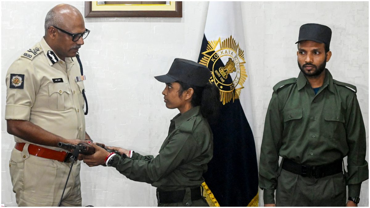 Maoist Malati surrenders her weapon before Kolkata Police Commissioner Ajay Kumar Nand as Maoist Mangal, right, looks on during a press conference, at Lalbazar police headquarters, in Kolkata, West Bengal | PTI