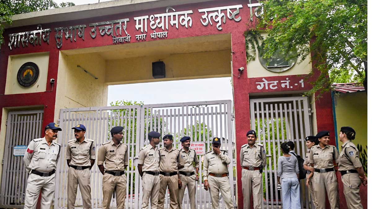 Police personnel stand guard outside an examination centre in Bhopal | PTI