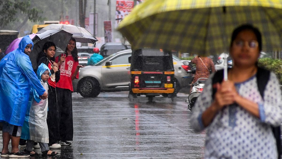 People cover themselves as they walk amid rainfall, in Mumbai, Maharashtra | PTI