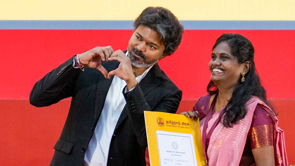 Tamil Nadu Chief Minister C Joseph Vijay presents an appointment order to a candidate during a function organised by the Energy Department at Kalaivanar Arangam in Chennai on June 24 | PTI