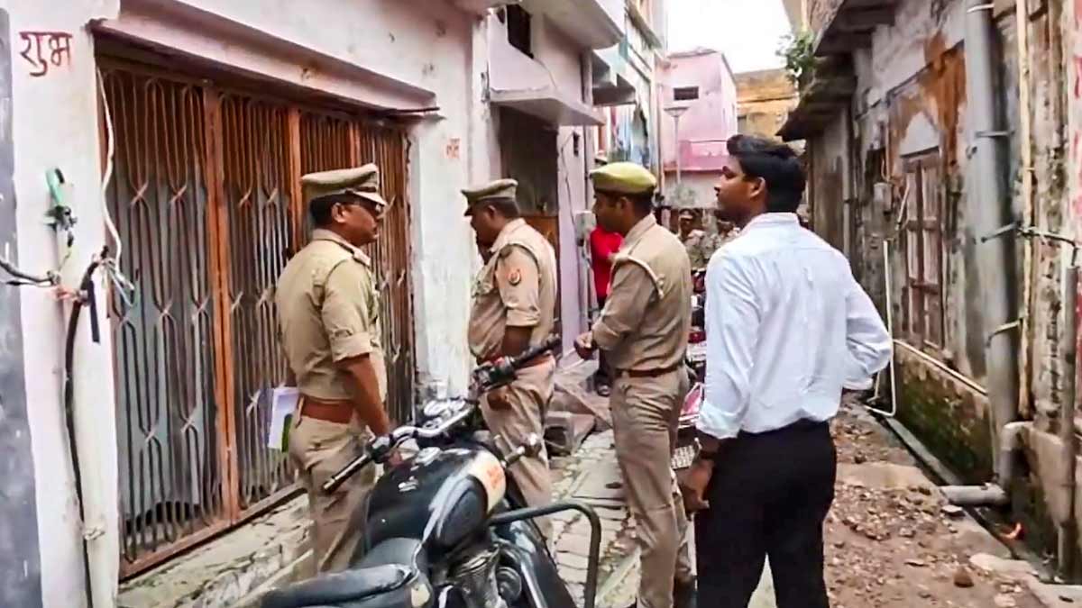 Police officials conduct a search operation at the residence of an accused in connection with an alleged embezzlement of donations at the Ram temple, in Ayodhya | PTI