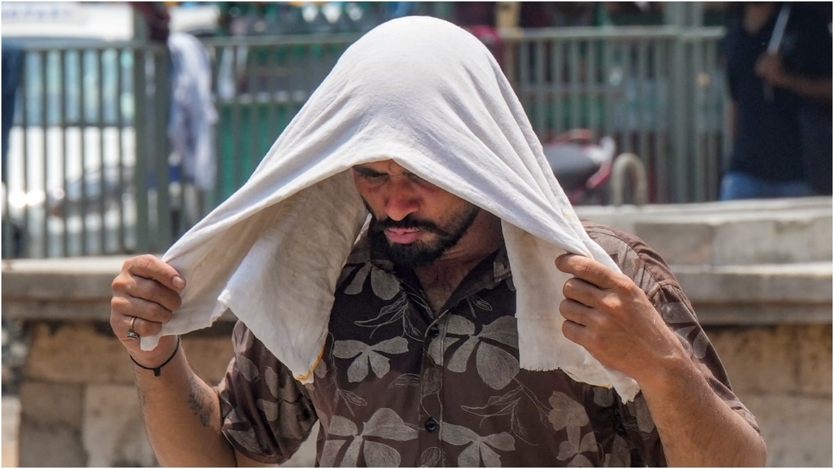  A man covers himself amid scorching summer heat in Kolkata | PTI