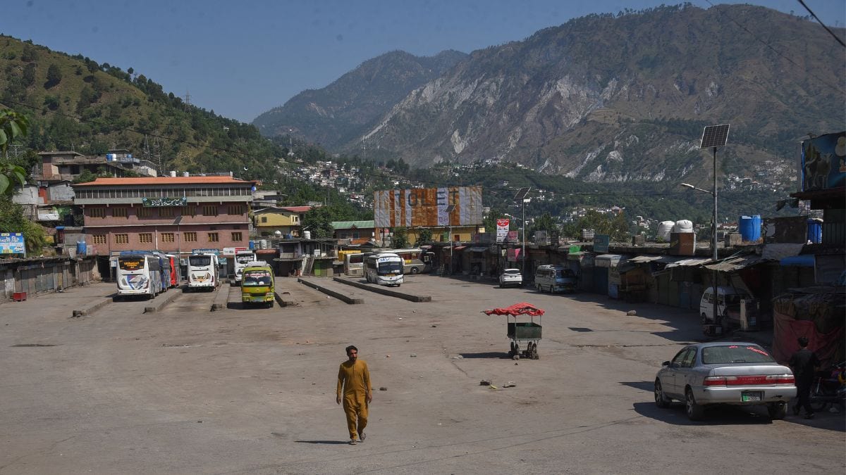 A local resident walks through a deserted bus terminal during a strike called by the Joint Awami Action Committee (JAAC) demanding greater political rights and the abolition of 12 legislative refugee seats, in Muzaffarabad, the capital of Pakistan-occupied Kashmir | PTI