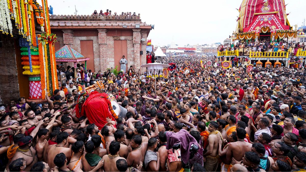 Priests and devotees gather during the annual Rath Yatra festival, at the Jagannath Dham in Puri, Odisha | PTI