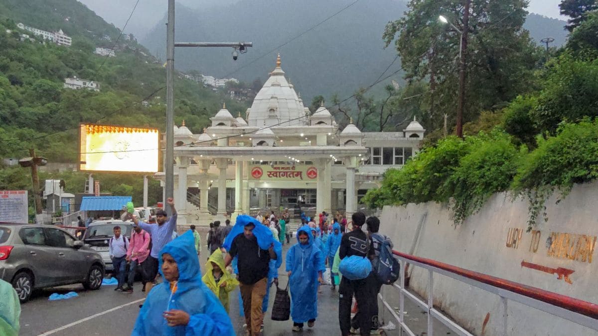 People gather near the Banganga entry gate after the Shri Mata Vaishno Devi Shrine Board suspends the pilgrimage due to adverse weather conditions, in Katra, Jammu and Kashmir | PTI