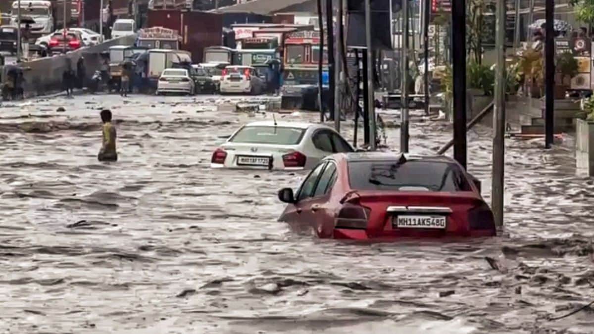 Vehicles remain partially submerged in a waterlogged road following heavy monsoon rain at Shilphata, in Navi Mumbai | PTI 
