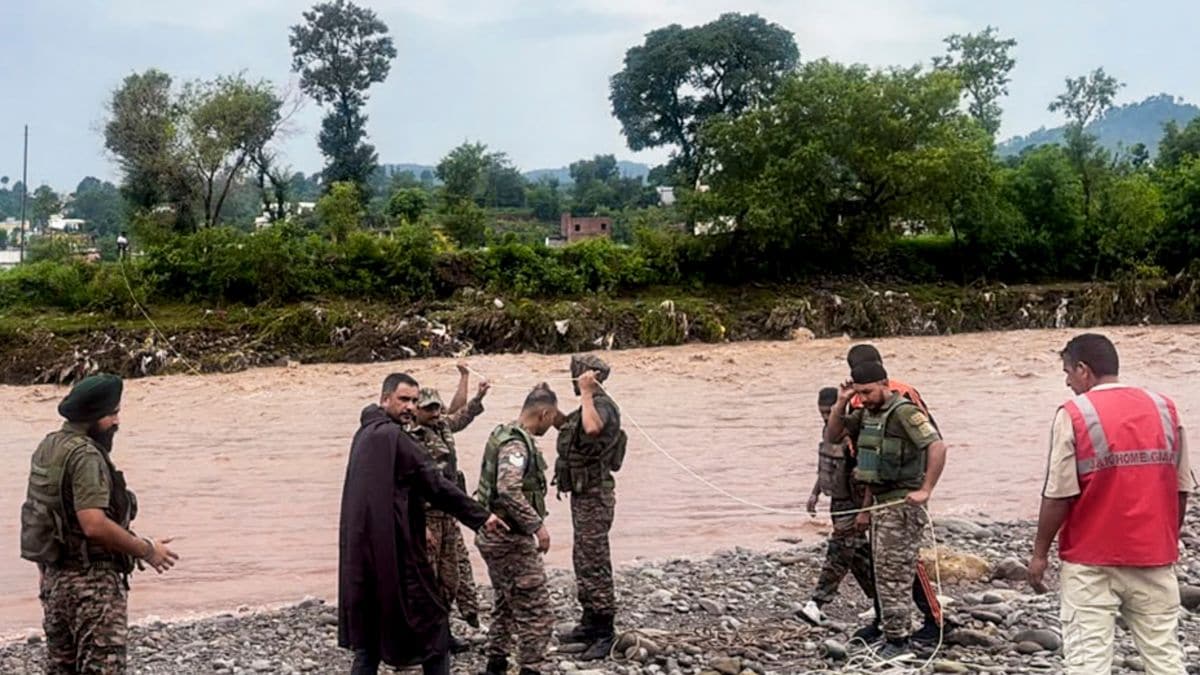 Rescue personnel conduct a rescue operation to rescue two men stranded in a river after flash floods caused by incessant overnight rainfall, in Rajouri, Jammu and Kashmir | PTI