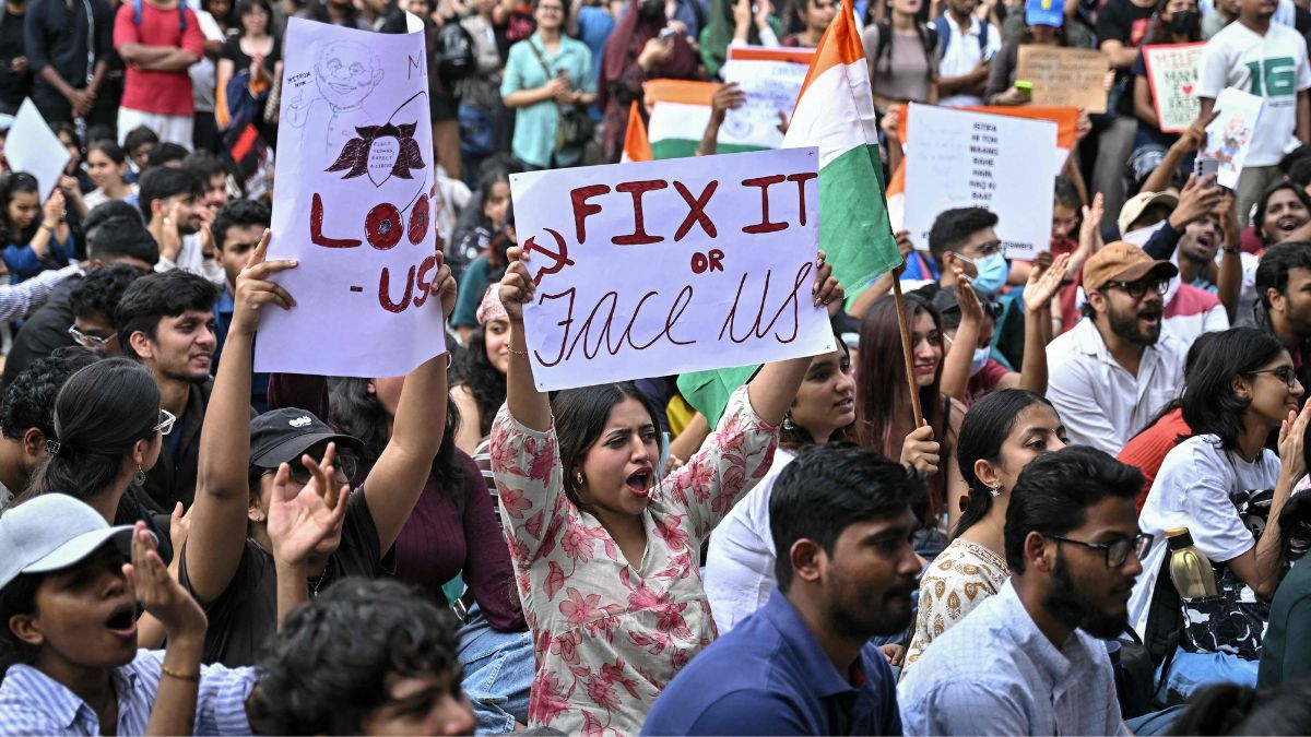 Demonstrators hold placards during a protest at Freedom Park in Bengaluru on July 22, 2026 in solidarity with the ongoing protest at New Delhi's Jantar Mantar demanding the resignation of India's Education Minister Dharmendra Pradhan | AFP