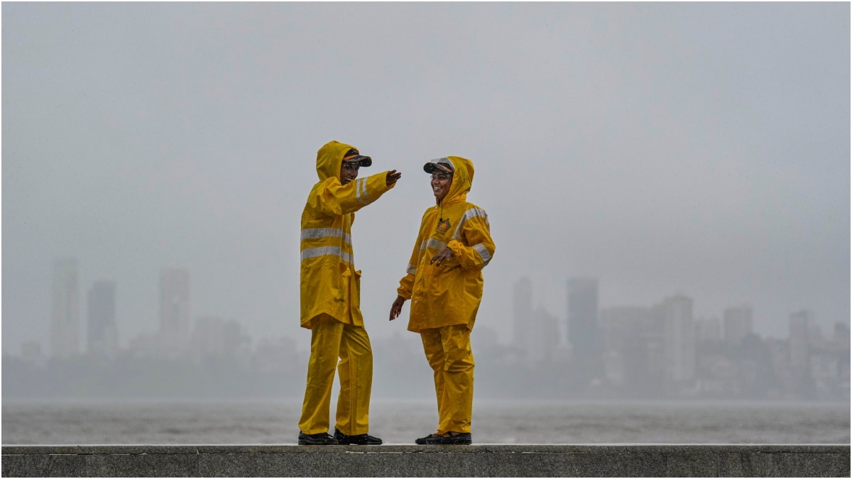 Mumbai Police personnel on a rainy day at Marine Drive | PTI