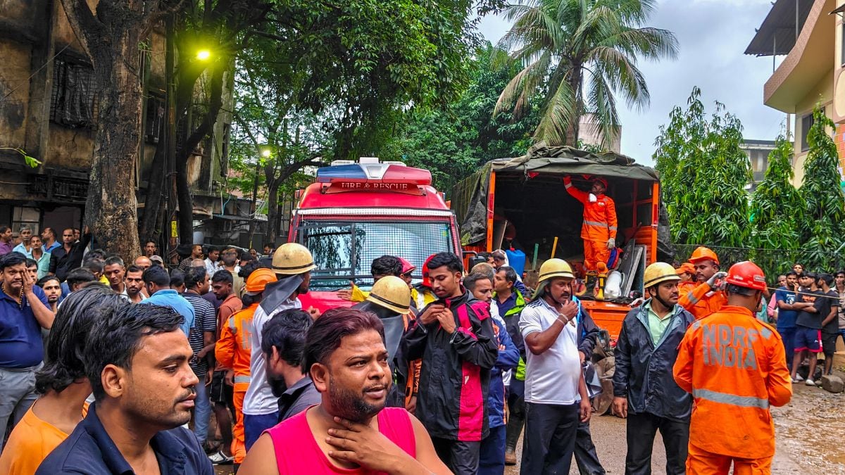 Rescue personnel and people gather at the site where a portion of the Kohinoor Building in Balaji Nagar area of the powerloom town collapsed on late Thursday, in Bhiwandi, Maharashtra | PTI