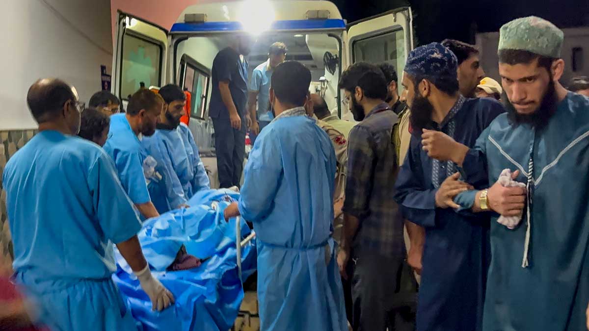 Medical personnel shift the injured migrant worker to an ambulance outside the Government Medical College Hospital after terrorists opened fire on two non-local labourers at a brick kiln in the Kellam area of Kulgam district, in Anantnag | PTI