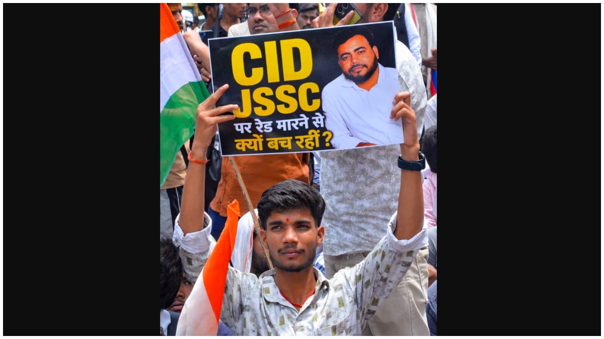 A student holds a placard as he takes part in a march towards Jharkhand Assembly as they stage a protest against the alleged JPSC-JSSC examination irregularities | PTI
