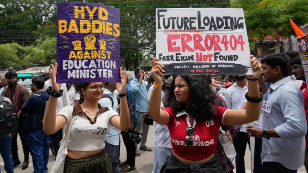 [File] Women display protest signs at a protest in Hyderabad in support of the Cockroach Janta Party on June 14, 2026 | AP