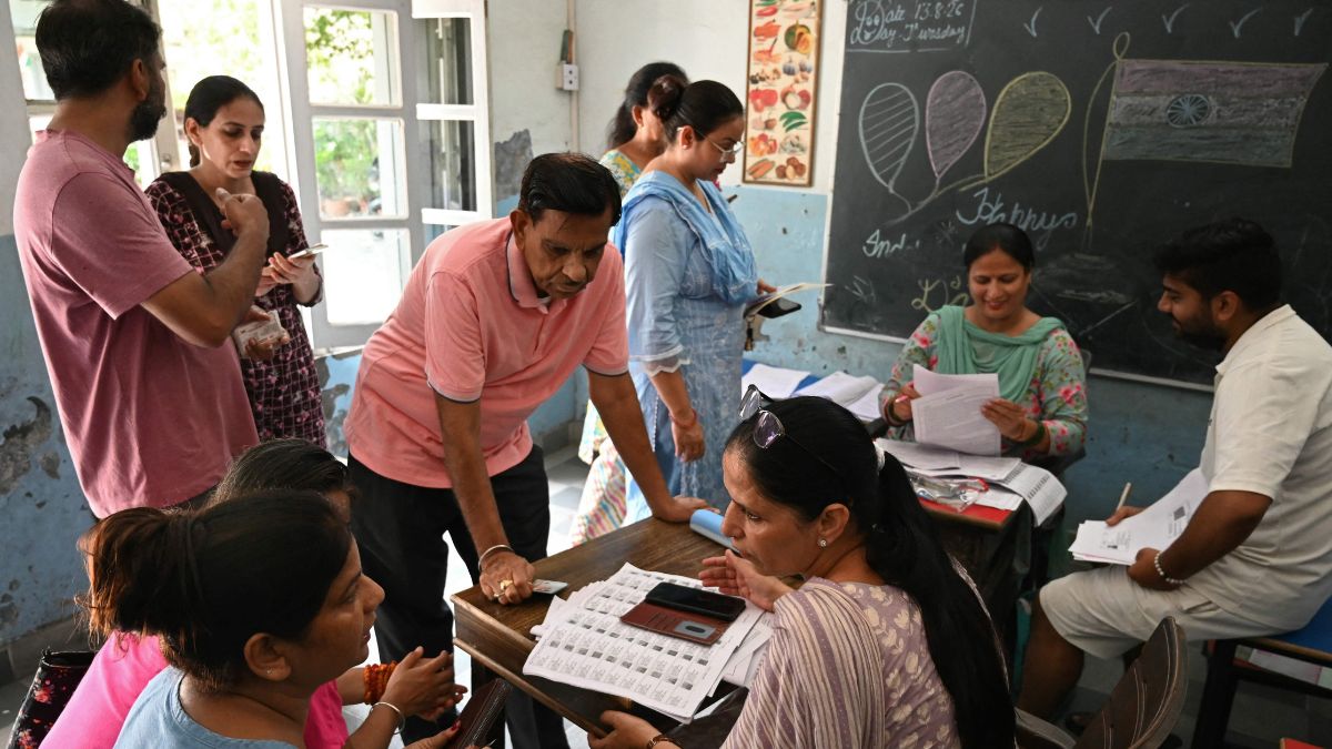 Booth Level Officers (BLOs) help voters check their names in the newly released Draft Electoral Roll 2026 as part of the Election Commission of India's Special Intensive Revision (SIR) | AFP