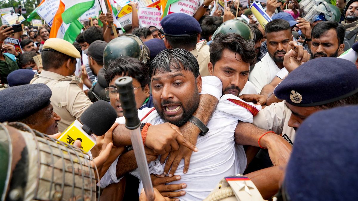 Police personnel try to evict members of the All Bihar Students' Union during their march against the state government over issues including paper leaks, unemployment and irregularities in recruitment, in Patna | PTI