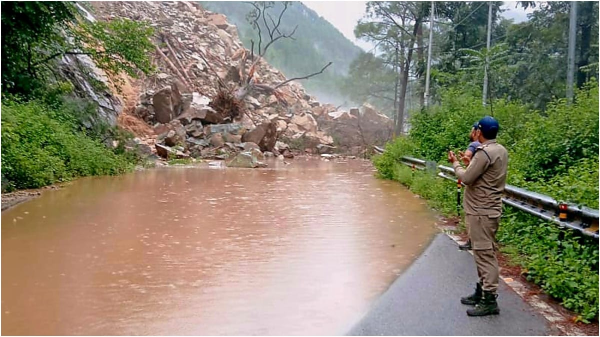 A police official looks on after debris fell onto the road due to incessant rainfall on the Badrinath National Highway, near Helang in Uttarakhands Chamoli district | PTI