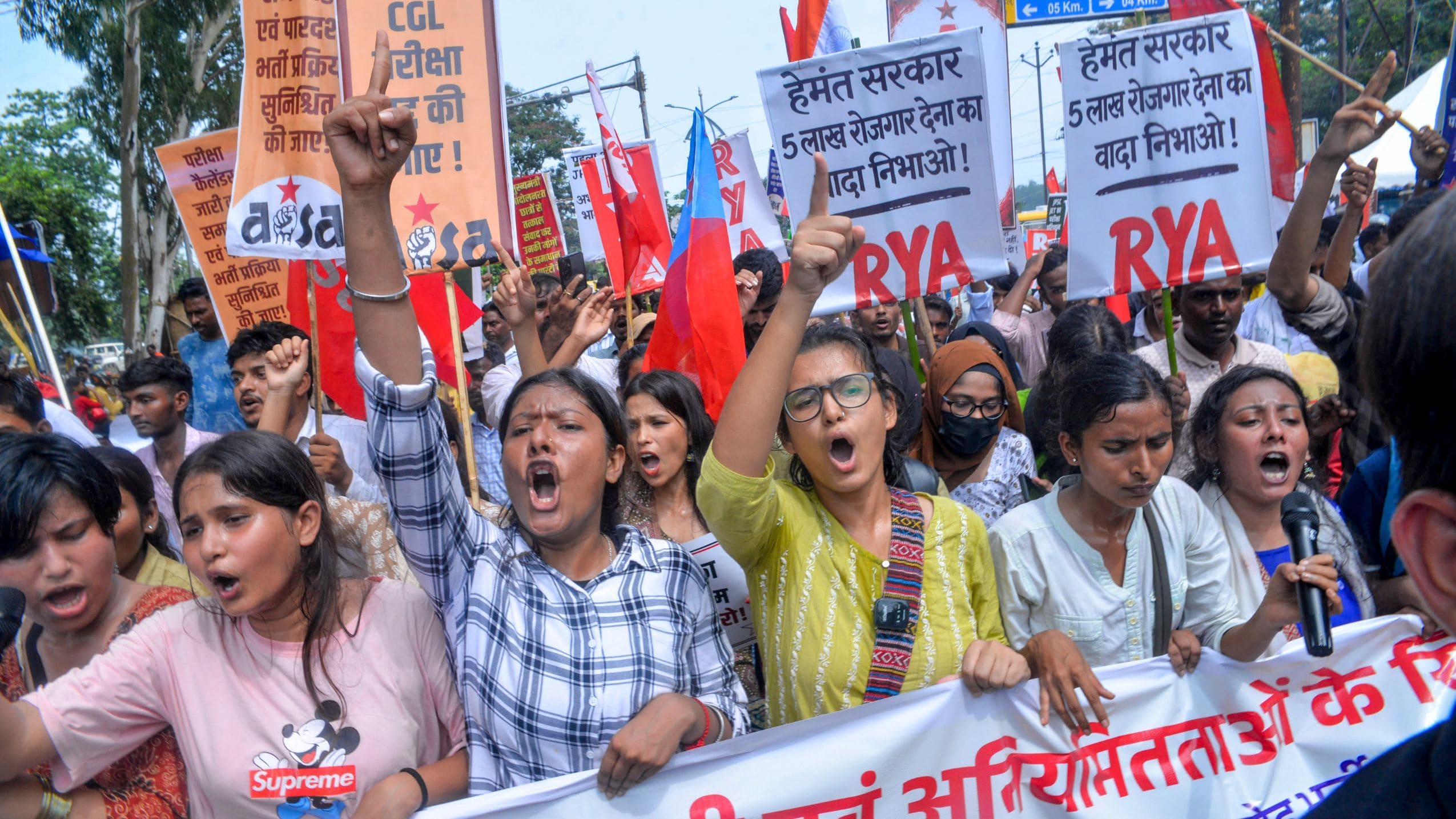 All India Student's Association (AISA) National President Neha Bora along with student demonstrators raise slogans as they take out a protest march against the alleged irregularities of exams and paper leak of JPSC and JSSC, in Ranchi | PTI