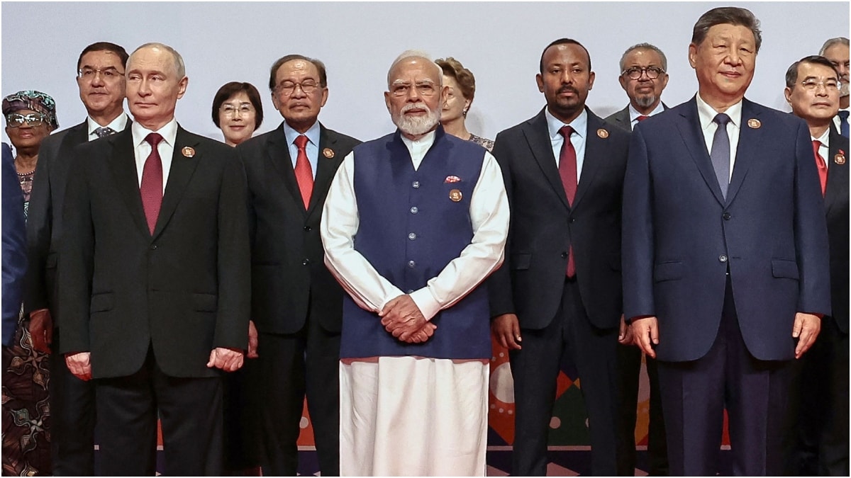 Russia's President Vladimir Putin (L), India's Prime Minister Narendra Modi (C) and China's President Xi Jinping (R) stand with other leaders for a family photo during the 18th BRICS Summit in New Delhi | AFP