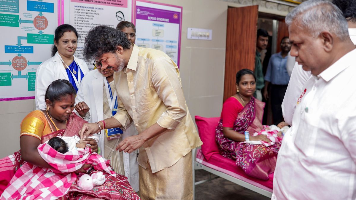 Tamil Nadu Chief Minister C Joseph Vijay presents a gold ring to a newborn baby during the launch of the state government's 'Thai Maman Thanga Mothiram' (Maternal Uncle's Gold Ring) scheme, in Madurai | PTI