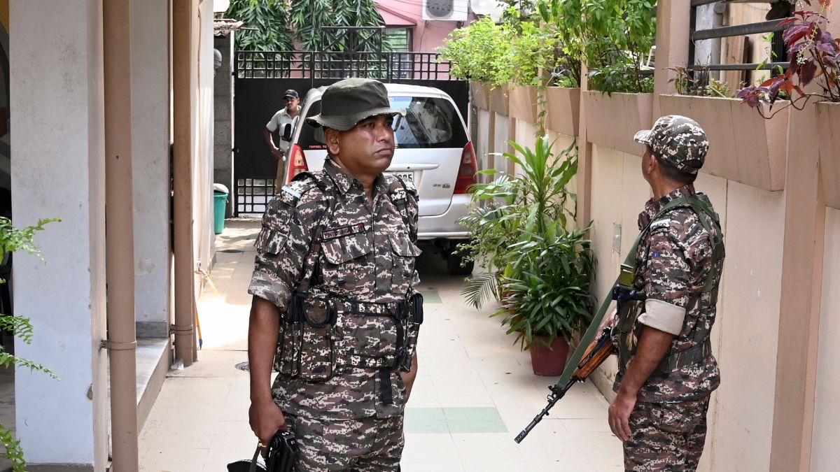 Security personnel stand guard as Enforcement Directorate (ED) officials conduct searches at the residence of former West Bengal minister Indranil Sen, in Kolkata, West Bengal | PTI
