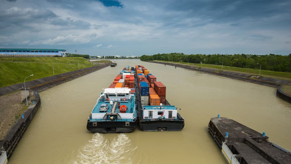 Representative image of a barge carrying container cargo through an inland waterway | Maersk